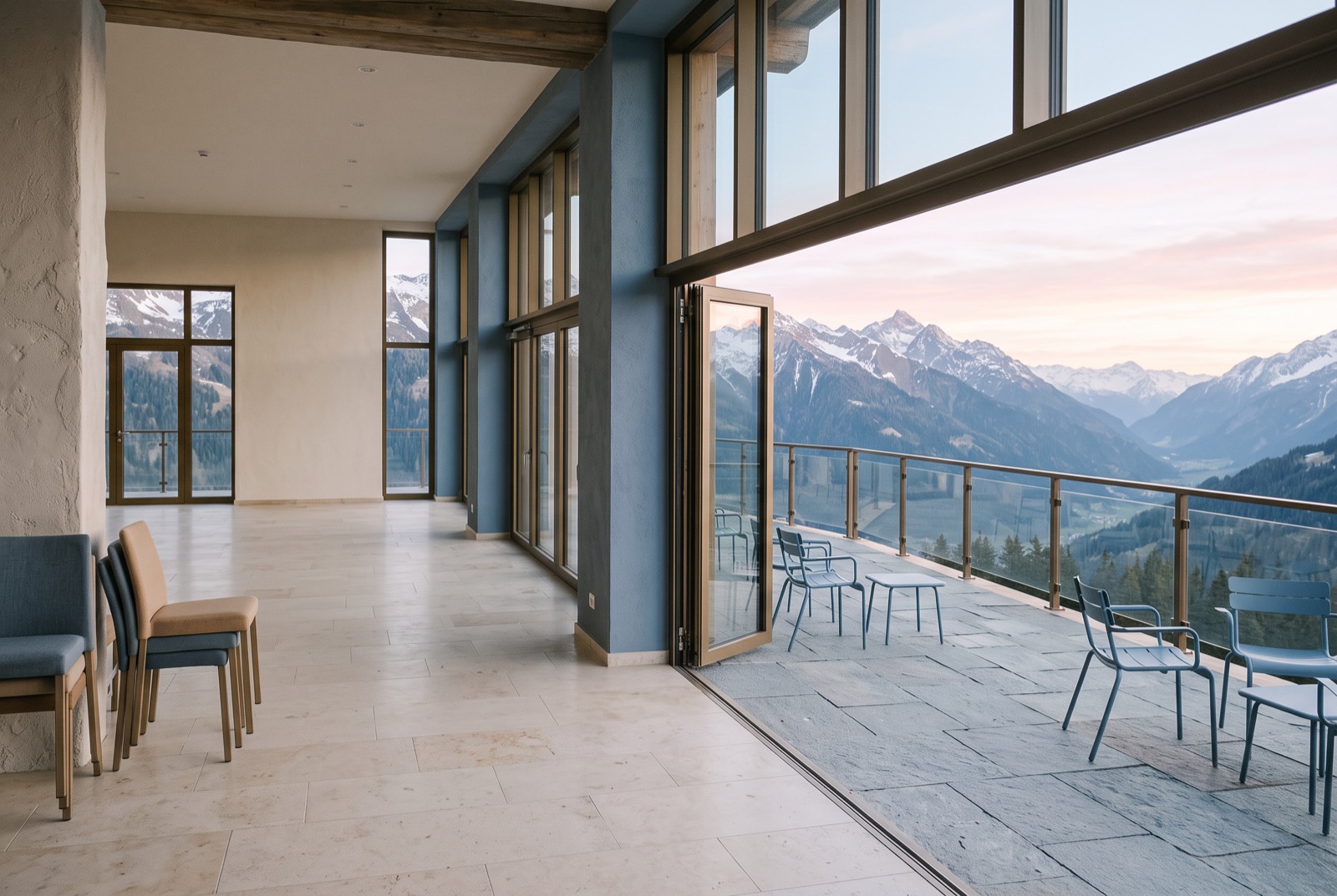 A congress hall terrace above an alpine valley at dawn
