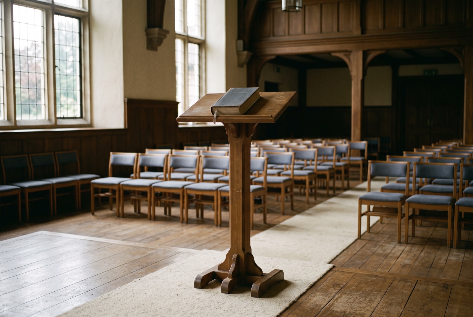 A lectern with a closed book in a quiet hall
