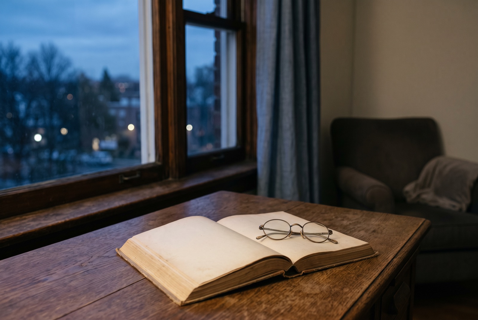 A reading desk with an open blank book and spectacles