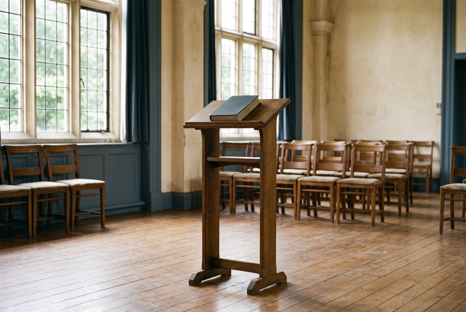 A lectern with a closed book in a quiet hall