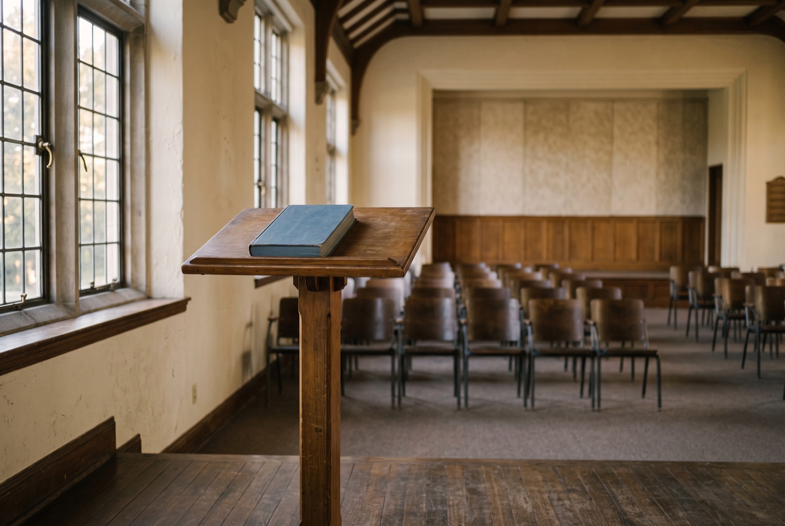 A lectern with a closed book in a quiet hall