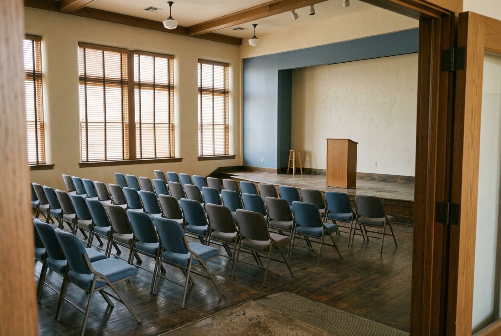 A small auditorium with a lectern and empty chairs before a pitch session