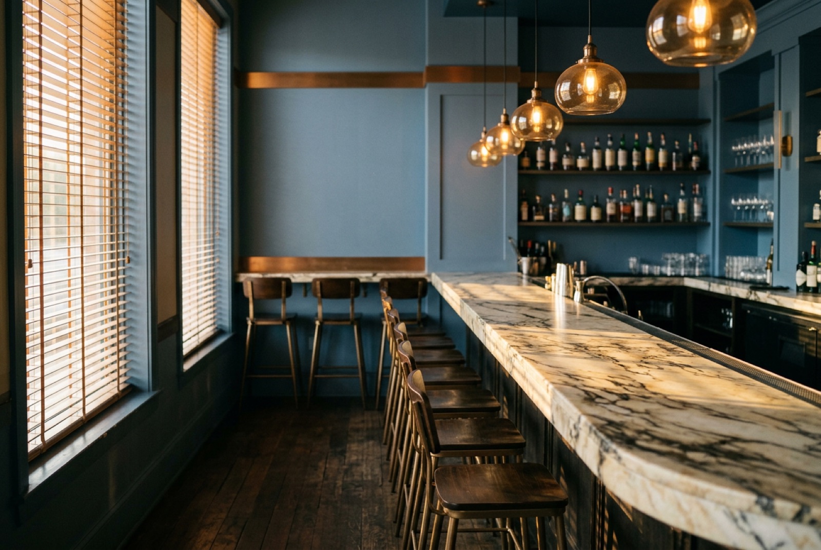 A club bar with a marble counter and low lamps in the afternoon
