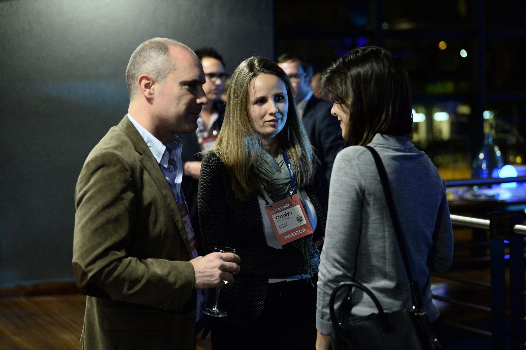 Investors and founders talking at a venture dinner in Lisbon